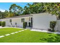 Well-maintained front yard with lush green grass, white rock accents, and manicured landscaping at 4019 W Bay To Bay Blvd, Tampa, FL 33629