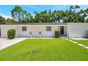 Inviting home exterior with lush green lawn, stepping stones, and manicured shrubbery at 4019 W Bay To Bay Blvd, Tampa, FL 33629