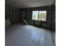 Bathroom featuring tiled floor, large window, and air conditioning unit in mid construction phase at 4129 Dolphin Dr # 103, Tampa, FL 33617