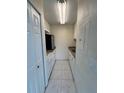 Functional kitchen with white cabinets, appliances, and tile flooring at 4148 Dolphin Dr # 3, Tampa, FL 33617