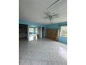 Spacious living room featuring tile floors, a ceiling fan, and access to other rooms at 4148 Dolphin Dr # 3, Tampa, FL 33617