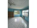 Bright living room featuring tile flooring, a ceiling fan and scenic lake views at 4148 Dolphin Dr # 3, Tampa, FL 33617