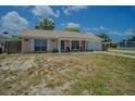 Attractive single-story home with a covered front porch, complete with an attached garage and well-maintained lawn at 4150 Woodsville Dr, New Port Richey, FL 34652