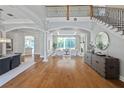 Open-concept living area boasts gleaming hardwood floors, archways, and a view to the backyard at 4512 Cheval Blvd, Lutz, FL 33558