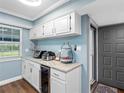 Cozy kitchen area featuring granite countertops, appliances, and a convenient entrance at 4943 New England Blvd # 105, New Port Richey, FL 34652