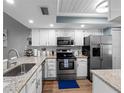 Well-equipped kitchen featuring stainless steel appliances and granite countertops at 4943 New England Blvd # 105, New Port Richey, FL 34652