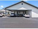 Convenient parking area with covered parking, landscaped features, and well-maintained asphalt at 4943 New England Blvd # 105, New Port Richey, FL 34652