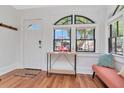 Bright foyer with wood floors, an arched window, and a charming table with decor at 513 W Paris St, Tampa, FL 33604
