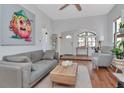 Open-concept living room with modern furnishings, wood floors, and lots of natural light at 513 W Paris St, Tampa, FL 33604