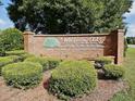 Entrance to the desirable Whispering Oaks Estates Golf and Country Club community, featuring lush landscaping at 5465 Chestnut Ridge Rd, Dade City, FL 33523