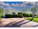 Driveway leads to a home featuring beautiful landscaping and mature, manicured privacy hedges at 5951 32Nd N Ave, St Petersburg, FL 33710