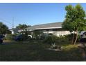 Charming single-story home with well-manicured lawn, mature landscaping, and cozy curb appeal at 611 N Bradford Ave, Tampa, FL 33609