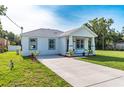 Inviting single-story home with a well-manicured lawn and a long driveway at 6215 N 44Th St, Tampa, FL 33610