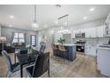 Stylish kitchen with stainless steel appliances, quartz countertops, and a cozy dining area at 6215 N 44Th St, Tampa, FL 33610