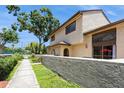 Townhome exterior showcasing its neutral color palette, trimmed windows and textured concrete perimeter wall at 6262 142Nd N Ave # 607, Clearwater, FL 33760