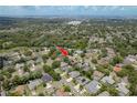 An aerial view of a property in a lush, green neighborhood at 627 Belted Kingfisher N Dr, Palm Harbor, FL 34683