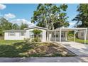 Charming single-story home with a well-kept front lawn and covered parking at 7110 Bonito St, Tampa, FL 33617