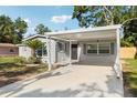 Well-lit front exterior with freshy painted carport and landscaping at 7110 Bonito St, Tampa, FL 33617