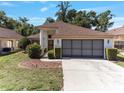 Inviting single-story home with manicured landscaping and a spacious driveway leading to the two-car garage at 9200 Halberg Dr, Hudson, FL 34669