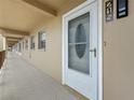 Exterior shot of front door with adjacent windows and long hallway, creating a welcoming entrance at 1 Boca Ciega Point Blvd # 215, St Petersburg, FL 33708