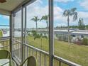 Enclosed lanai showcasing a beautiful view of the surrounding lush landscaping and waterfront at 1 Boca Ciega Point Blvd # 215, St Petersburg, FL 33708