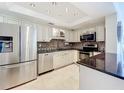 Modern kitchen boasts stainless steel appliances, granite countertops, and updated cabinetry for a sleek design at 100 Pierce St # 910, Clearwater, FL 33756