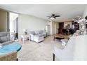 Open floorplan living room with neutral tones, comfortable seating, and views of the water and kitchen area at 100 Pierce St # 910, Clearwater, FL 33756