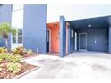 Modern facade showcasing a colorful exterior, mature landscaping, and covered parking at 111 Chesapeake Ave, Tampa, FL 33606