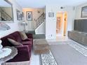 Comfortable living room showing staircase, a view of the hallway, and stylish decor at 11764 Raintree Dr # 0, Temple Terrace, FL 33617