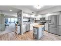 Bright kitchen with stainless steel appliances, granite countertops, and a convenient center island at 1200 Country Club Dr # 6302, Largo, FL 33771