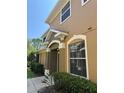 Close-up of the home's exterior featuring architectural details and manicured shrubs at 12631 Silverdale St, Tampa, FL 33626