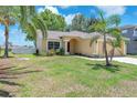 Single story home featuring a well manicured lawn and tropical landscaping at 13437 Beechberry Dr, Riverview, FL 33579