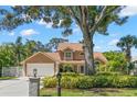Charming single-Gathering home showcasing lush front yard, mailbox, and a driveway leading to the garage at 13598 Park Blvd, Seminole, FL 33776