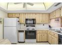 Functional kitchen layout with wooden cabinetry, essential appliances, and a bright, practical design for everyday cooking at 172 Lakeview Way # 172, Oldsmar, FL 34677
