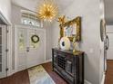 Welcoming entryway with a decorative light fixture, hardwood floors, and stylish decor at 18003 Arbor Crest Dr, Tampa, FL 33647