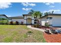 Lovely home with a well-kept lawn, decorative landscaping, and a bright yellow front door at 1801 Sagebrush Rd, Plant City, FL 33566