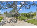 Attractive single story home with a well-maintained lawn, gated front yard, and convenient driveway at 1827 Oregon Ne Ave, St Petersburg, FL 33703