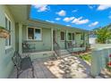 Welcoming covered front porch with seating and a tiled entryway, offering a cozy outdoor space at 1827 Oregon Ne Ave, St Petersburg, FL 33703