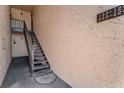 Outdoor stairwell leading to upper-level condo units with address numbers at 224 Aspen Cir # 224, Seminole, FL 33777