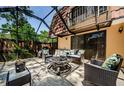 Cozy enclosed patio with tile floors, modern seating, and an inviting fire pit at 2706 11Th Ct, Palm Harbor, FL 34684