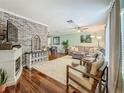 Spacious living room with hardwood floors, comfortable seating, and a decorative fireplace at 3093 Hillside Ln, Safety Harbor, FL 34695