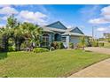 Charming single-story home with a well-manicured lawn, mature trees, and lush landscaping at 378 Wood Chuck Ave, Tarpon Springs, FL 34689