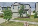 Two-story home with a two-car garage, landscaping and sidewalks at 3810 Romano Busciglio St, Tampa, FL 33619