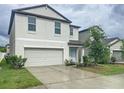 Charming two-story home featuring a two-car garage, with blue colored front door at 3810 Romano Busciglio St, Tampa, FL 33619
