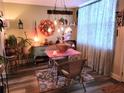 Cozy dining area featuring eclectic decor, a pink table, and unique lighting fixture for intimate meals at 4705 1St Ne St # 326, St Petersburg, FL 33703