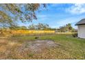 Open backyard showcasing ample space and a wooden fence, perfect for outdoor activities at 5526 Southernview Dr, Zephyrhills, FL 33541