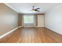 Spacious living room features hardwood floors, neutral paint, ceiling fan and a large window at 6015 19Th N St # 311, St Petersburg, FL 33714
