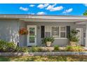 A quaint front porch displays decorative hanging baskets and potted plants adding to the homes curb appeal at 707 24Th Sw St, Largo, FL 33770