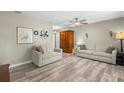 Open-concept living room featuring hardwood floors, neutral paint, a ceiling fan, and comfortable seating at 707 24Th Sw St, Largo, FL 33770