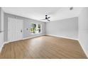Bedroom featuring a ceiling fan, light gray walls, wood floor, and a bright window at 8504 N 17Th St, Tampa, FL 33604